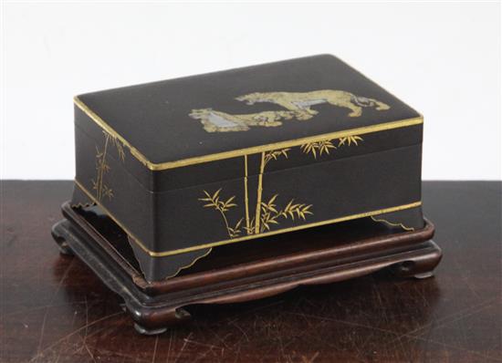 A Japanese gold and silver inlaid iron box and cover, signed Komai, Meiji period, 11cm, rosewood stand